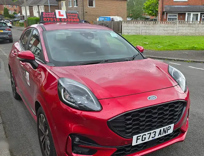 Photo of red Ford Puma with Shift Smart Driving School branding